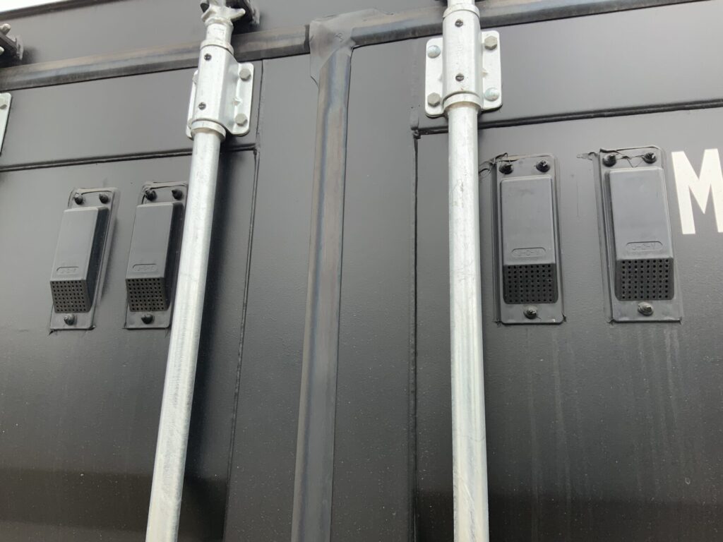 Close-up of four factory-fitted ventilation ports on the front cargo doors of ContainerKing® asset KNG72374, promoting natural airflow inside the shipping container.