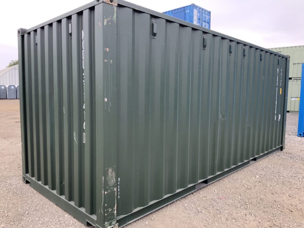 Rear and side view of a one-trip 20ft Bottle Green shipping container showing cosmetic corner pillar scratching, corrugated steel panels and excellent overall condition.