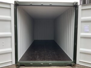 Immaculate interior of a premium one-trip 20ft ISO shipping container with clean steel walls, black 25mm marine plywood floor and full-height cargo doors.