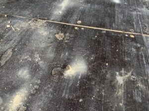 Cosmetic floor surface damage inside a 20ft one-trip bottle green ISO shipping container showing honest condition of marine plywood floor.