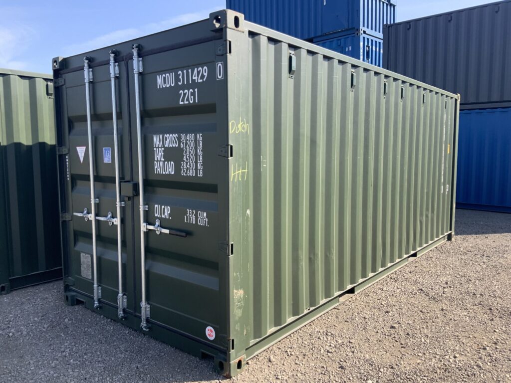 Front and side view of brand-new Bottle Green RAL6007 20ft one-trip ISO shipping container KNG72385 at the ContainerKing® depot in Lincolnshire.